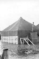 Tents surrounded by water in flat areas