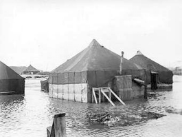 Tents surrounded by water in flat areas