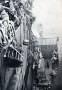 Artillerymen with their howitzer and 105mm ammunition being transferred from transport to landing craft. [The Capture of Attu, pg. 109]