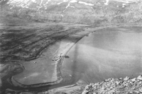 The west arm of Holtz Bay viewed from the ridge over which the troops advanced into Attu. Note the crashed Japanese Zero on the beach. [U. S. Army photo]