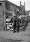 J. Rene "Frenchy" Thibault standing by the door of the Guard Shack, Attu, 1946.  [Rene Thibault]