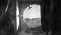 Adak, Dec 1942/43, as viewed through transport port hole. [Mack Collings]