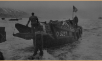 Scene at Attu's Massacre Bay beach; Americans bring ashore a captured Jap landing boat. [U. S. Navy Photo]