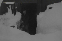 Walter H. Knight in front of his Attu hut. 1944-1945. [Walter H. Knight]