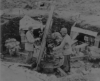 Troops looking over a captured Japanese gun emplacement. May 1943.  [George Villasenor]