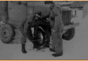 Amchitka. Changing a tire at the motor pool. [Al Gloeckler]