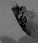 Don't remember his name...standing in doorway of his Quonset hut buried in snow.  [Bill Greene]