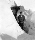 Don't remember his name...standing in doorway of his Quonset hut buried in snow.  [Bill Greene]