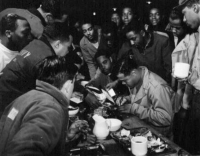 Joe Louis signs autographs for the troops, 1945 Attu. [George Villasenor]