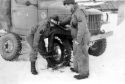 Amchitka. Changing a tire at the motor pool. [Al Gloeckler]