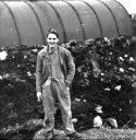 46. Al outside of a Quonset hut on Attu. The huts had to be dug in 3 feet because the wind was so strong. [All Gloeckler]