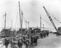This was the squadron on the dock across the bay from Umnak preparing to load on those barges which took us across in the middle of the night. We arrived at Umnak at 4:00 am. Cold.  [Don Blumenthal]