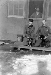 11. I'm in the doorway, the man on the left I don't remember his name, the guy on the right is Robert Basford. He went to Drew field with me.  [Ed Sidorski}