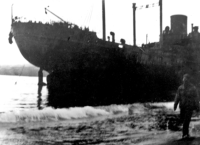 Docked ship, location unknown. May be Dutch Harbor, Adak, or Attu.  [Sam Shout]