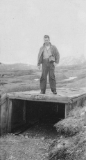 Shelton standing on the entrance to a Japanese tunnel.  [Elbert McBride]