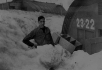 Brodie in front of his Hut, digging out the snow. [Robert Brodie]