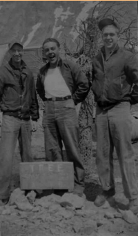 Brodie, Nissing, Boraske posing near the only "tree" (man made) on Attu. [Robert Brodie]