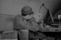 Listening to the radio in a Quonset hut on Attu - person unknown.  (Amchitka?)  [Al Gloecker]