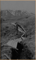 Mac McBride standing near a Japanese covered trench.  [Elbert McBride]