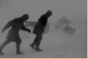 PP and Sam walking in 70-knot winds. The CO ordered us to travel in pairs. Attu, 1945.  [Elbert McBride]