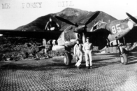 P-38 and crew, Alexai Point, Attu, AK. Notice the Perforated Steel Plating (PSP) runway! [George L. Smith]