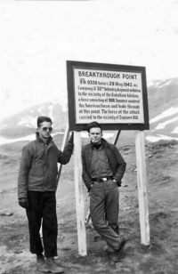 Howard Miles and George Brown on Attu at the "Breakthrough Point" sign. [Robert Brodie]