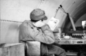 Listening to the radio in a Quonset hut on Attu - person unknown.  (Amchitka?)  [Al Gloecker]