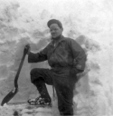 Shoveling into a Quonset hut on Attu. Person unknown.  [Al Gloecker]