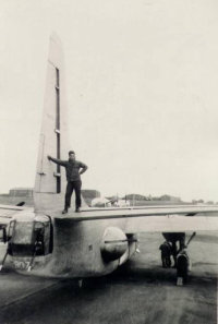 Tony Suarez Leaning On Vertical Tail of PB4Y-2, Shemya 1945-46. [Tony Suarez]